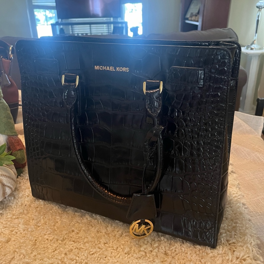 Black Michael Kors tote with imprinted alligator pattern
